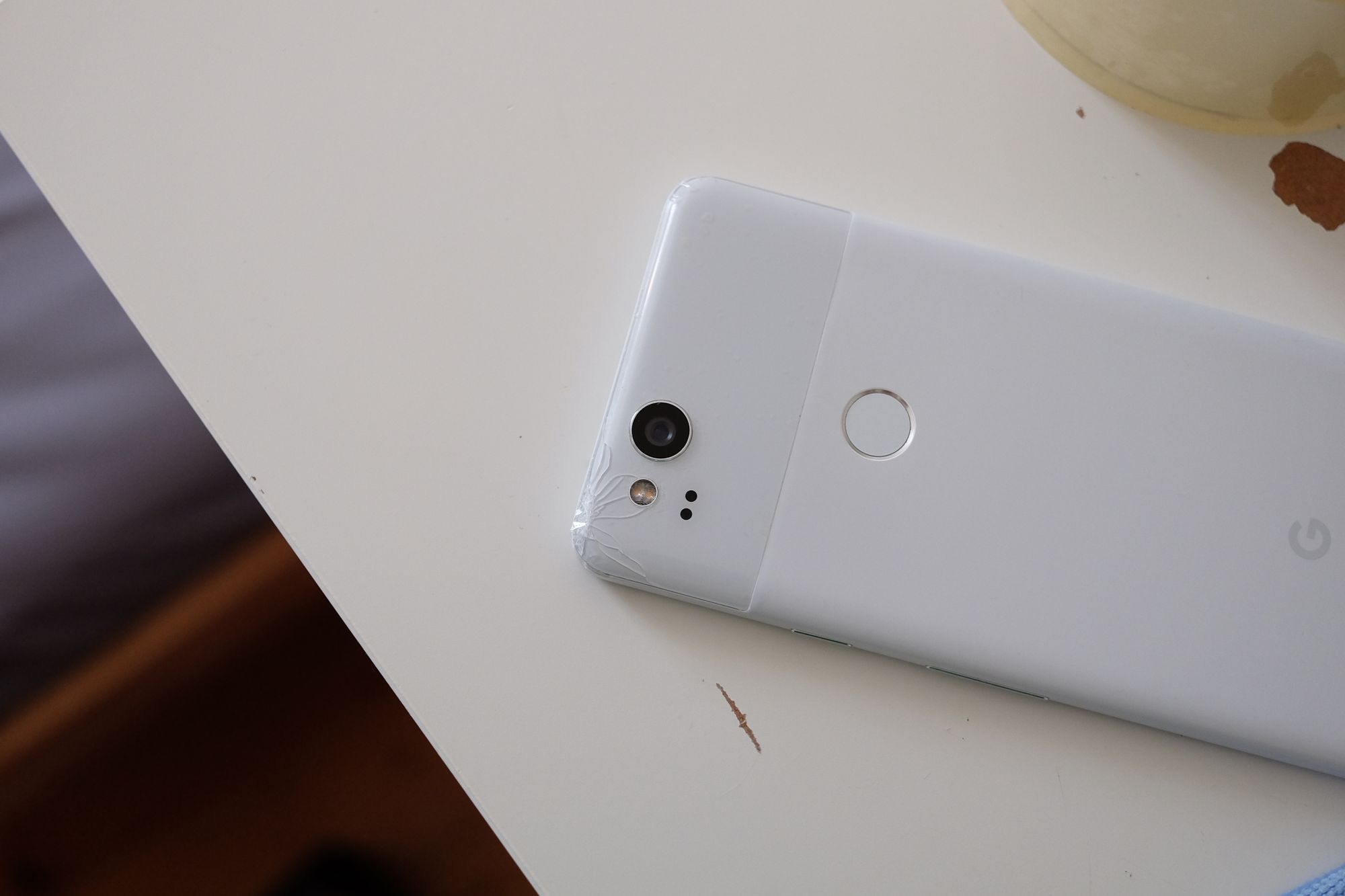 A white Pixel 2 with a cracked back glass