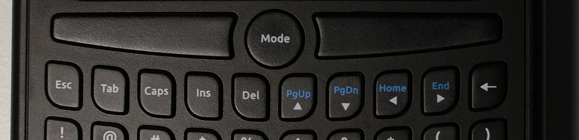 Zoomed in on the top row of the keyboard, which shows the 4 arrow keys on the same row horizontally 