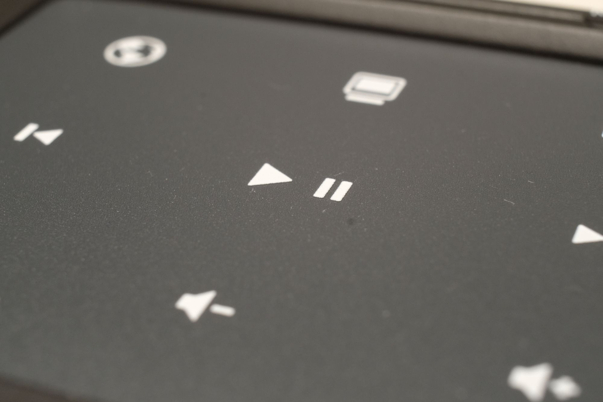 Macro photo of the trackpad, which shows the slightly textured surface, along with the set of functions keys available (Play/Pause, Previous, Next, Volumn Down, Volumn Up, and more.)