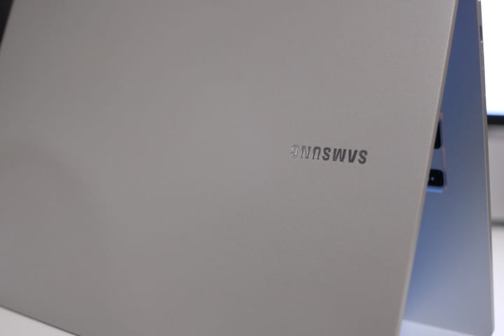 Close-up of a silver laptop, slightly ajar, standing upside down